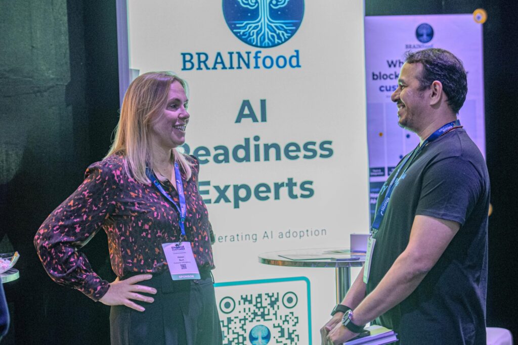 Visitors talking at the Brainfood AI Readiness Experts stand