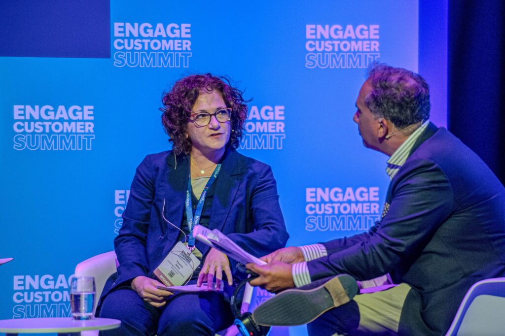 Brian Manusama interviewing a panellist on stage